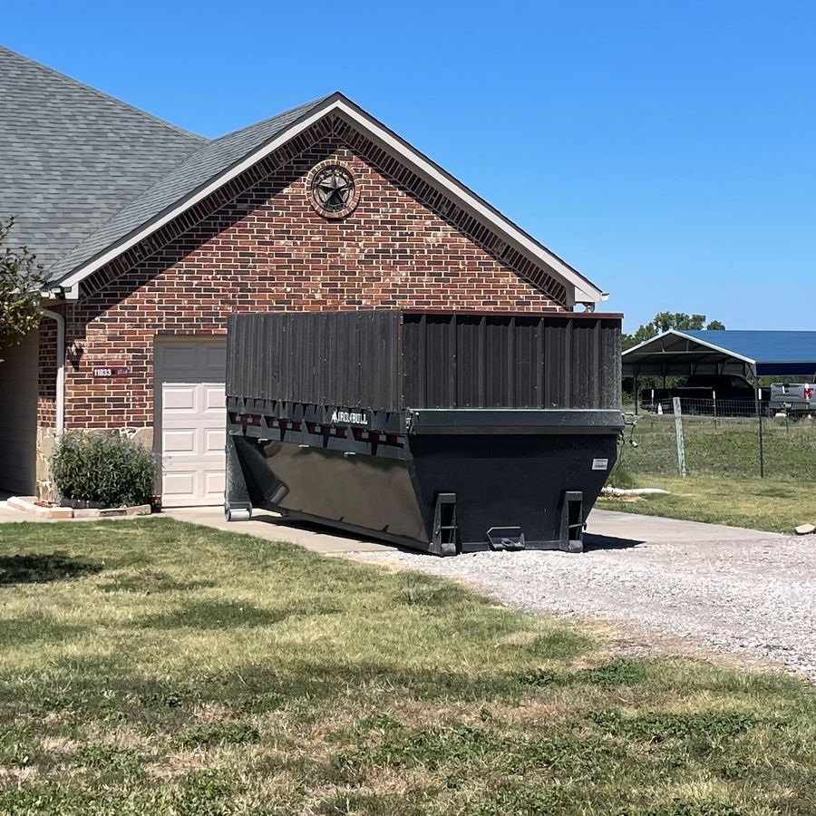 Country Cousins roll-off dumpster parked in front of a residential home in Northeast DFW