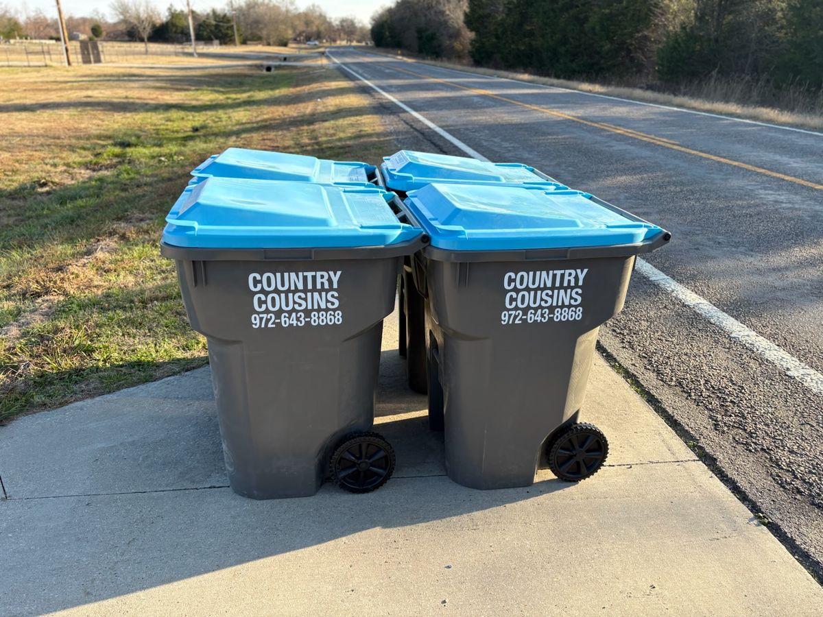 Four Country Cousins branded trash carts lined up for service in Northeast DFW