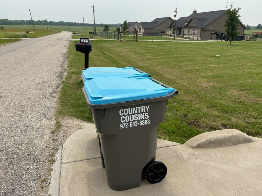 Country Cousins branded trash carts at the curb in a Farmersville TX neighborhood